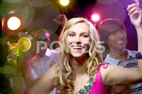 Portrait of a beautiful blonde girl in nightclub looking at camera and smiling Stock Photos