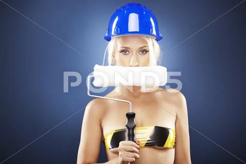 Portrait of a beautiful blonde model holding a roller brush covering her mout Stock Photos