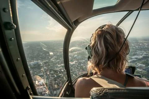 Portrait of beautiful blonde women enjoying helicopter flight. She is amazed  Stock Photos