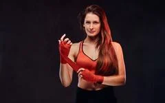 Photograph: Portrait of a female boxer in a sports bra and red