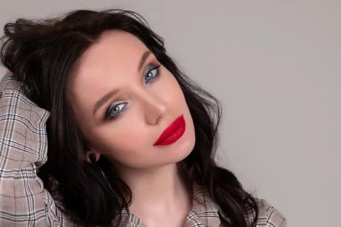 Portrait of a beautiful brunette with red lips. Stock Photos