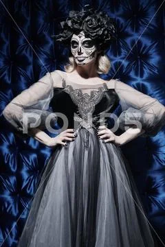 Portrait of a beautiful Calavera Catrina. Fashion model with sugar skull make Stock Photos
