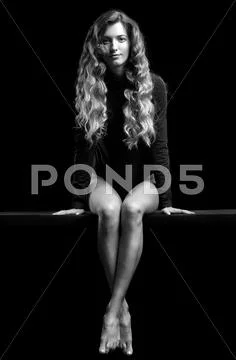 Portrait of beautiful caucasian model posing on black cloth on black backgrou Stock Photos