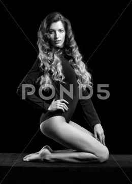 Portrait of beautiful caucasian model posing on black cloth on black backgrou Stock Photos
