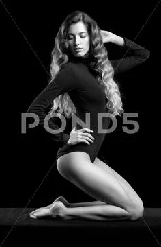 Portrait of beautiful caucasian model posing on black cloth on black backgrou Stock Photos