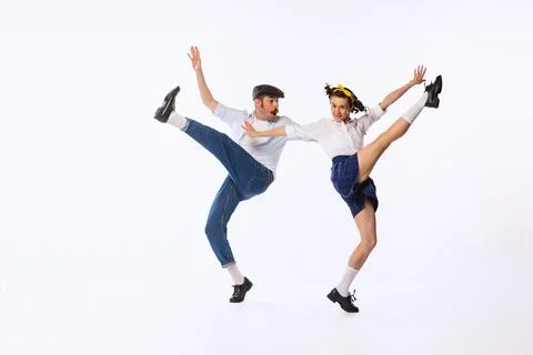 Portrait of beautiful couple, man and woman, dancing isolated over white studio Stock Photos
