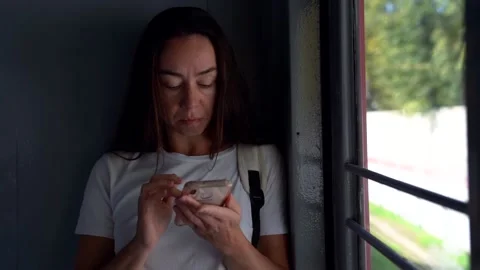 Portrait of a beautiful dark-haired middle-aged woman looking at her phone. She Stock Footage