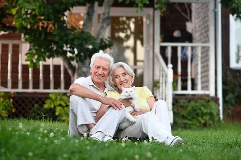 Portrait of a beautiful elderly couple in summer park Stock Photos