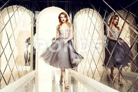 A portrait of a beautiful elegant woman in the evening dress. Fashion, evenin Stock Photos