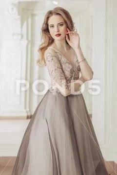 A portrait of a beautiful elegant woman in the evening dress. Fashion, evenin Stock Photos