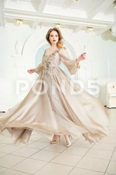 A portrait of a beautiful elegant woman in the fluttering wedding dress. Fash Stock Photos