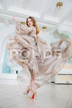 A portrait of a beautiful elegant woman in the fluttering wedding dress. Fash Stock Photos