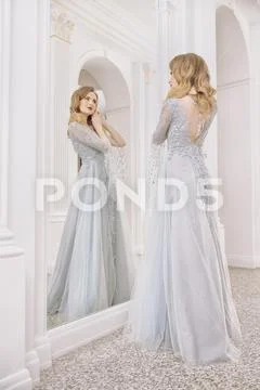 A portrait of a beautiful elegant woman in the fluttering wedding dress. Fash Stock Photos