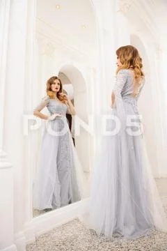 A portrait of a beautiful elegant woman in the fluttering wedding dress. Fash Stock Photos