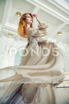 A portrait of a beautiful elegant woman in the fluttering wedding dress. Fash Stock Photos
