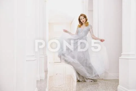 A portrait of a beautiful elegant woman in the fluttering wedding dress. Fash Stock Photos