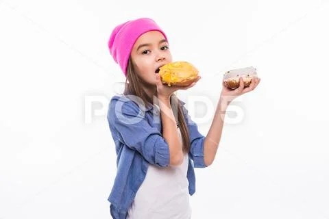 Portrait of a beautiful girl eat a donut on her finger Stock Photos