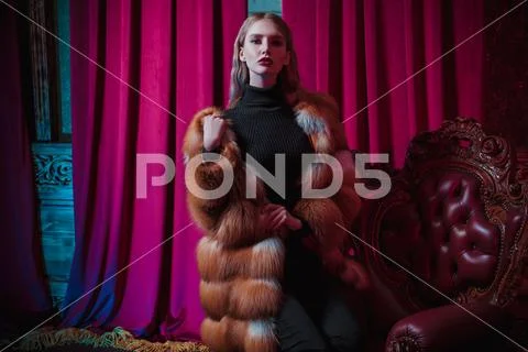 A portrait of a beautiful girl wearing a fur coat. Beauty, winter fashion. Stock Photos