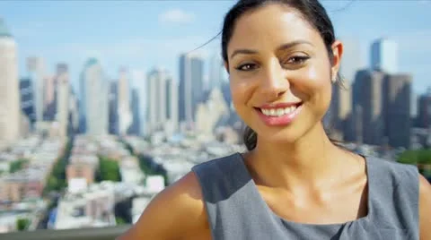 Portrait of beautiful Hispanic manager on rooftop overlooking city   Stock Footage 11977827