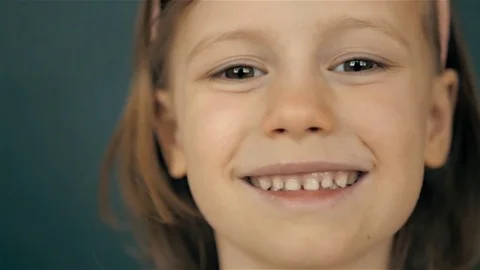 Portrait of a beautiful liitle girl close-up, smiling kid child Stock Footage