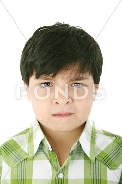 Portrait of beautiful little boy with serious look isolated on white backgrou Stock Photos