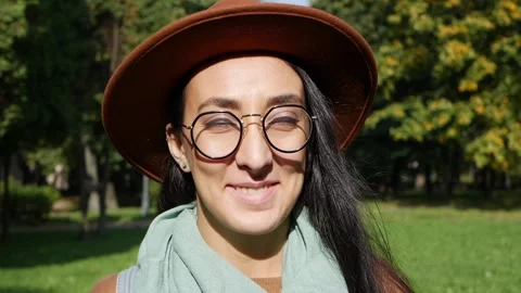 Portrait of a beautiful middle eastern smiling woman at sunny day. Autumn park Stock Footage 143483829
