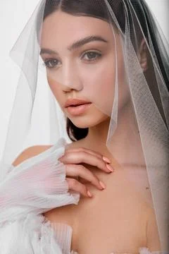 Portrait beautiful model posing standing by clean white wall. Wedding photo Foto stock