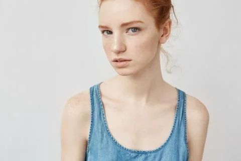 Portrait of beautiful natural redhead girl with freckles looking at camera Stock Photos