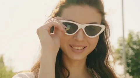 Portrait of beautiful smiling model dressed in summer hipster jeans shorts Stock Footage 142347587
