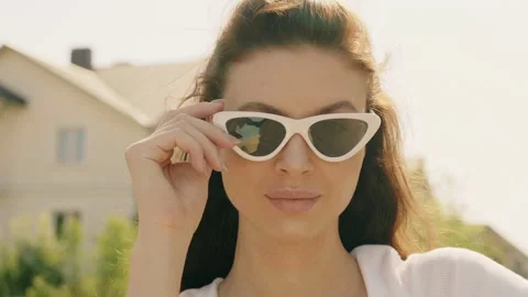 Portrait of beautiful smiling model dressed in summer hipster jeans shorts Stock Footage 142347756