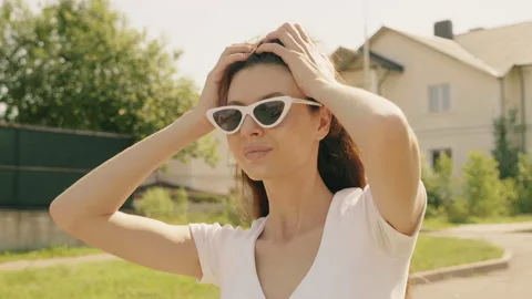 Portrait of beautiful smiling model dressed in summer hipster jeans shorts Stock Footage 142348356