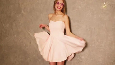 Portrait of beautiful smiling model in pink flying dress 動画素材 140802577
