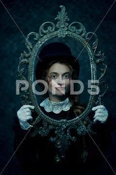 Portrait of a beautiful Victorian woman in an old vintage frame. Steampunk. Stock Photos