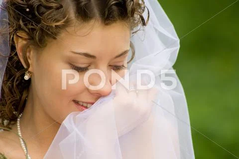 Portrait of beautiful woman with chiffon veil in a natural environment Stock Photos