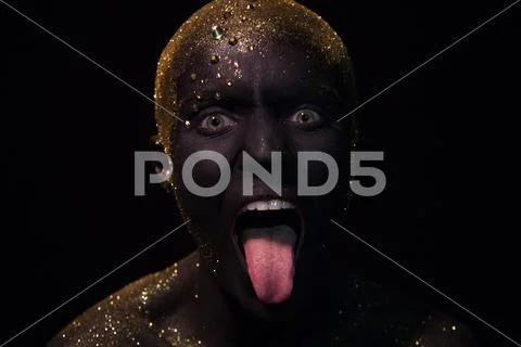 Portrait of a beautiful woman with creative body art glowing make up. Face is Stock Photos