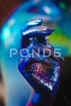 Portrait of beautiful woman painted with cosmic colors and spangled. Stock Photos