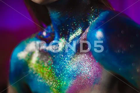 Portrait of beautiful woman painted with cosmic colors and spangled. Stock Photos