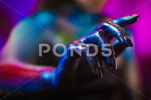 Portrait of beautiful woman painted with cosmic colors and spangled. Stock Photos