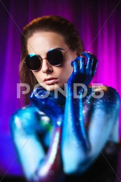 Portrait of beautiful woman painted with cosmic colors and spangled. Stock Photos