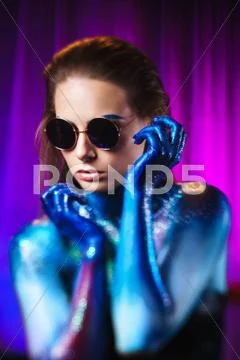 Portrait of beautiful woman painted with cosmic colors and spangled. Stock Photos