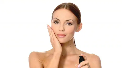 Portrait of beautiful woman, she is applying cosmetics base on face Stock Footage
