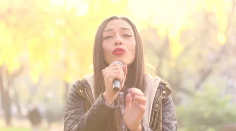 Portrait of beautiful woman singing with microphone Stock Footage 59556597