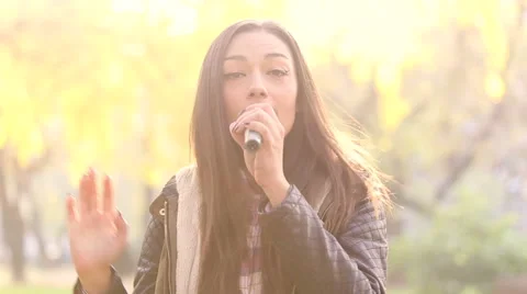 Portrait of beautiful woman singing with microphone Stock Footage 59556606