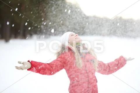 Portrait of beautiful woman taking pleasure on snowy winter day Stock Photos