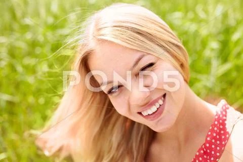Portrait of a beautiful woman winking at you and smiling Stock Photos