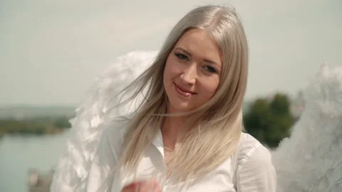 Portrait of beautiful young blonde posing and standing on rooftop in city Stock Footage 148008680