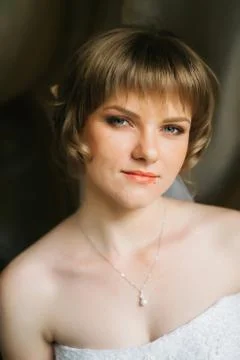 Portrait a beautiful young bride on the background of fabrics Stock Photos