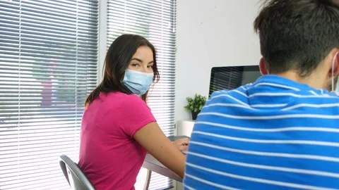 Portrait of beautiful young student in classroom wearing a surgical mask Video stock 139037892