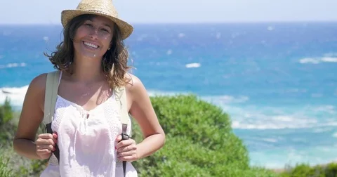 Portrait of a beautiful young tourist (girl), in a white dress, looks Stock Footage