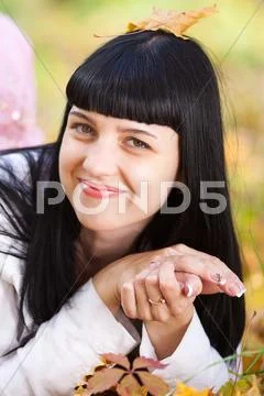 Portrait of a beautiful young woman in autumn forest Stock Photos